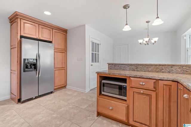 kitchen featuring appliances with stainless steel finishes, hanging light fixtures, light tile patterned floors, a notable chandelier, and light stone counters