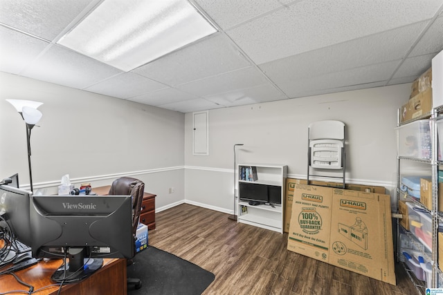 office space featuring a drop ceiling, dark hardwood / wood-style flooring, and electric panel