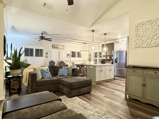 living room featuring vaulted ceiling, ceiling fan, and light hardwood / wood-style floors