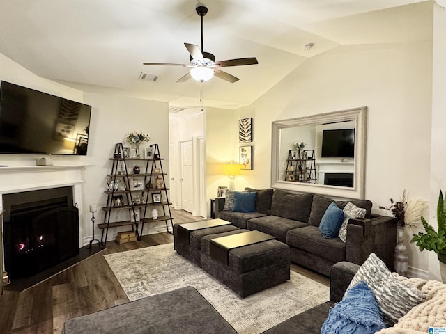 living room with vaulted ceiling, ceiling fan, and light wood-type flooring