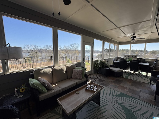 sunroom / solarium featuring ceiling fan and a wealth of natural light