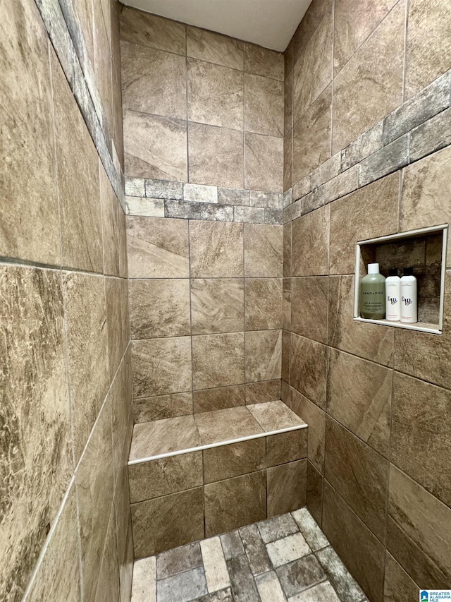 bathroom featuring a tile shower