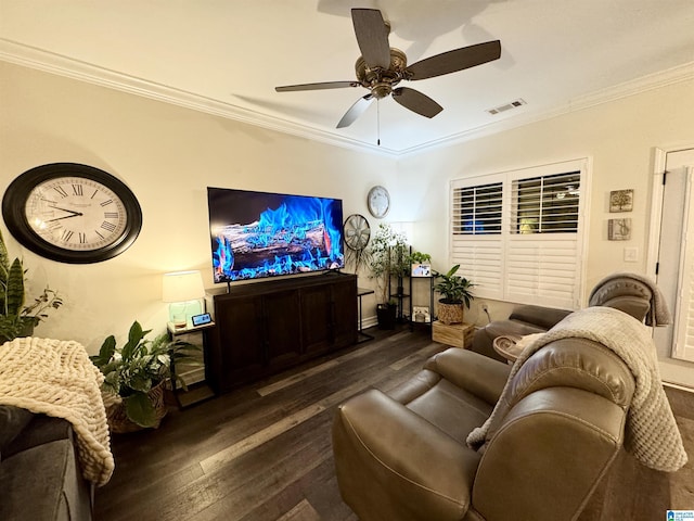 living room featuring dark wood-type flooring, ornamental molding, and ceiling fan