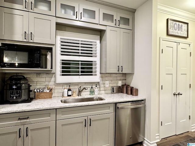 bar with sink, black microwave, stainless steel dishwasher, dark hardwood / wood-style floors, and light stone countertops