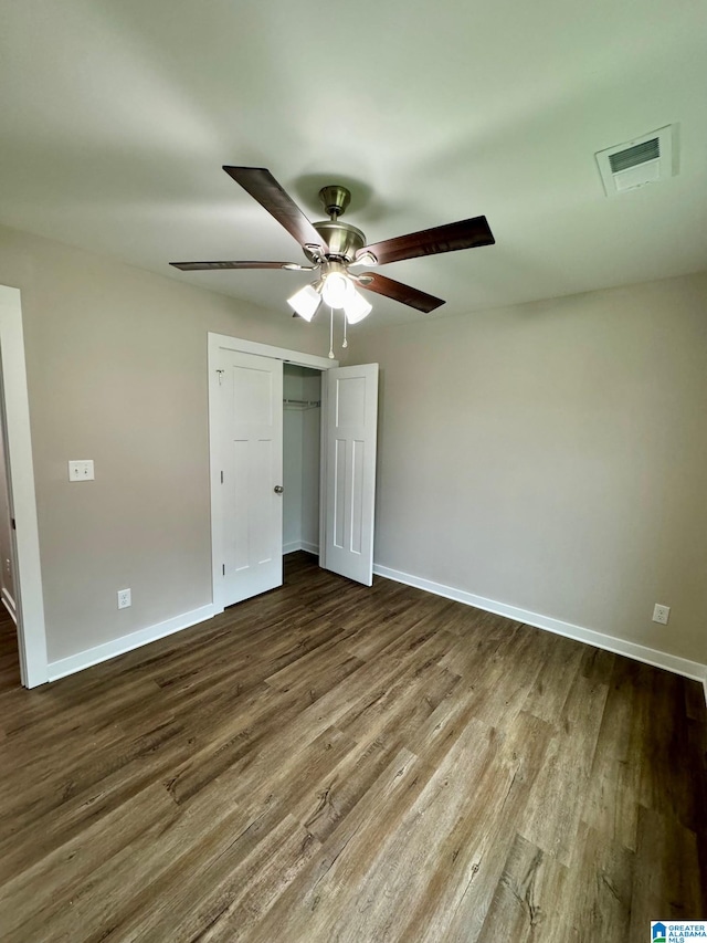 unfurnished bedroom with hardwood / wood-style floors, a closet, and ceiling fan