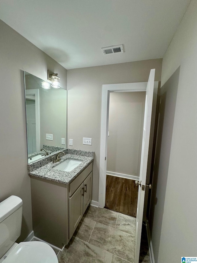 bathroom with vanity and toilet