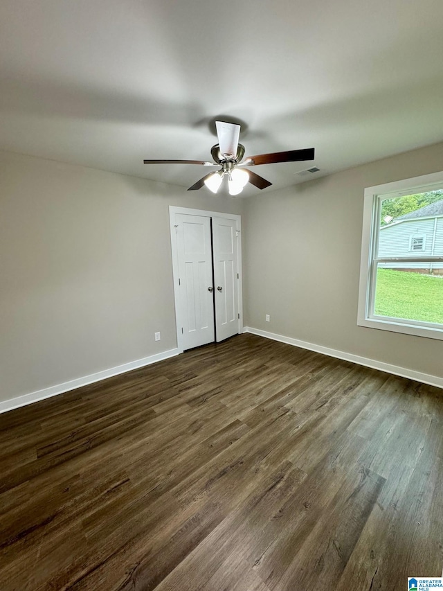 unfurnished bedroom with dark wood-type flooring and ceiling fan