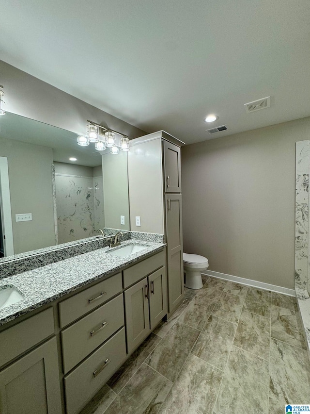 bathroom featuring vanity, toilet, and walk in shower