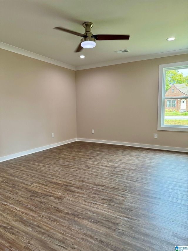 unfurnished room with dark hardwood / wood-style flooring, ornamental molding, and ceiling fan