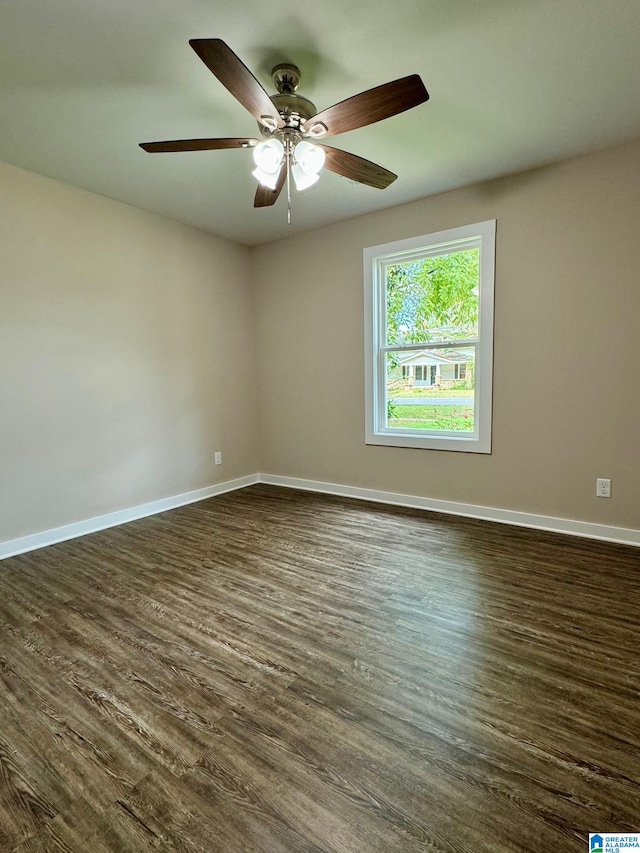 spare room with ceiling fan and dark hardwood / wood-style flooring