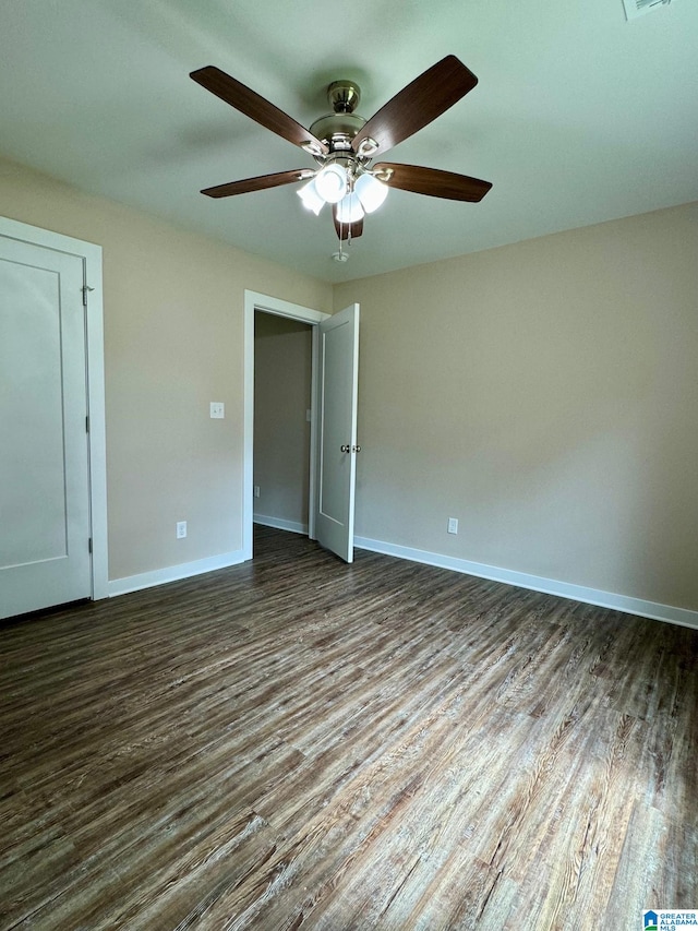 unfurnished bedroom with ceiling fan and dark hardwood / wood-style floors