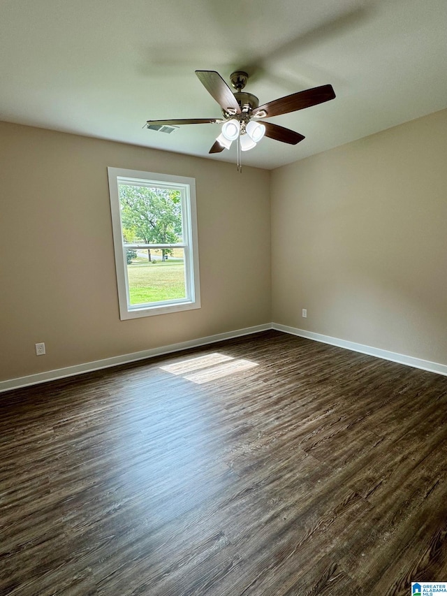 unfurnished room with ceiling fan and dark hardwood / wood-style floors