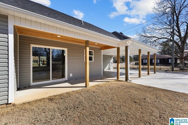 back of house featuring a patio area and a lawn