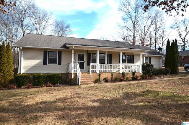 ranch-style house with a front yard and covered porch