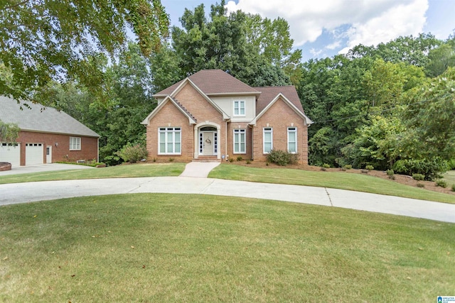 view of front of house featuring a garage and a front lawn