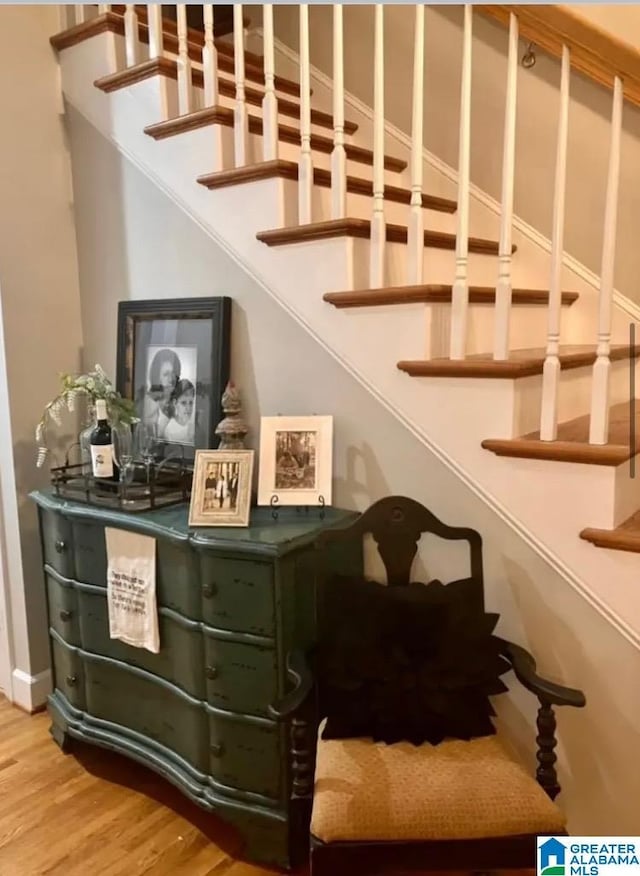 stairs featuring hardwood / wood-style floors