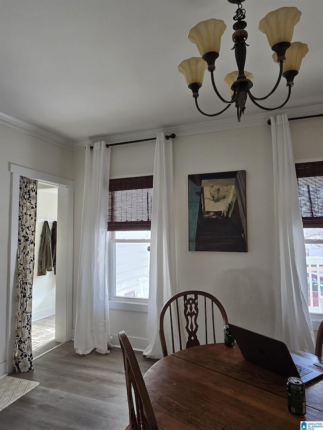 dining space featuring a notable chandelier, crown molding, and hardwood / wood-style floors