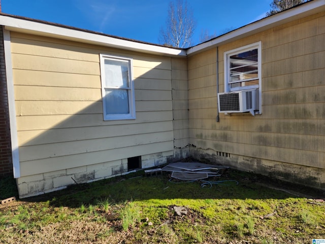 view of side of home with cooling unit and a yard