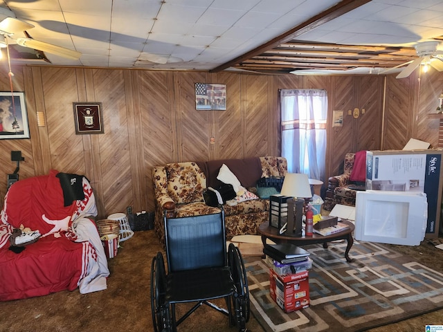 carpeted living room with wooden walls and ceiling fan