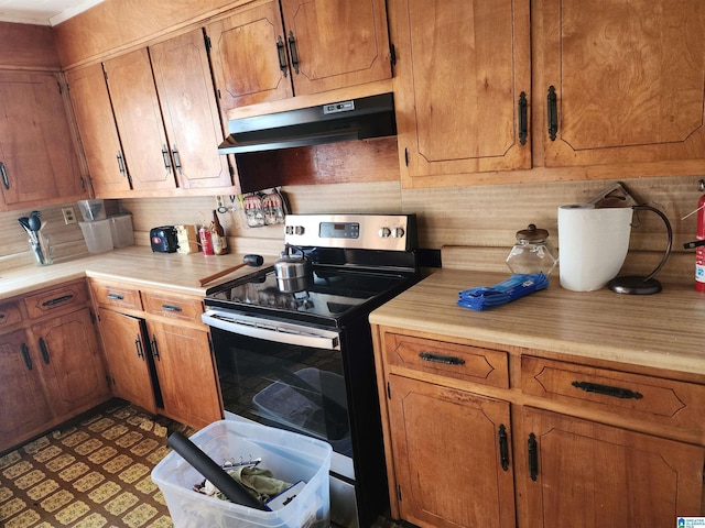 kitchen featuring backsplash and electric range