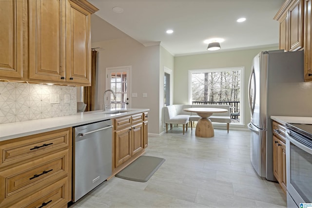 kitchen featuring stainless steel appliances, plenty of natural light, sink, and decorative backsplash