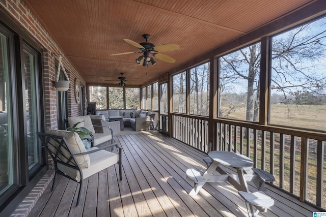 sunroom featuring wood ceiling and a healthy amount of sunlight