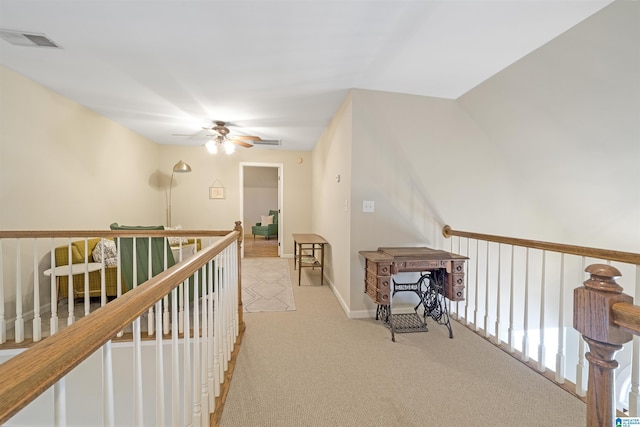 hallway with light colored carpet