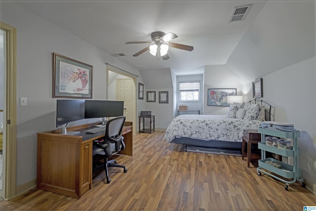 bedroom featuring ceiling fan, wood-type flooring, and lofted ceiling