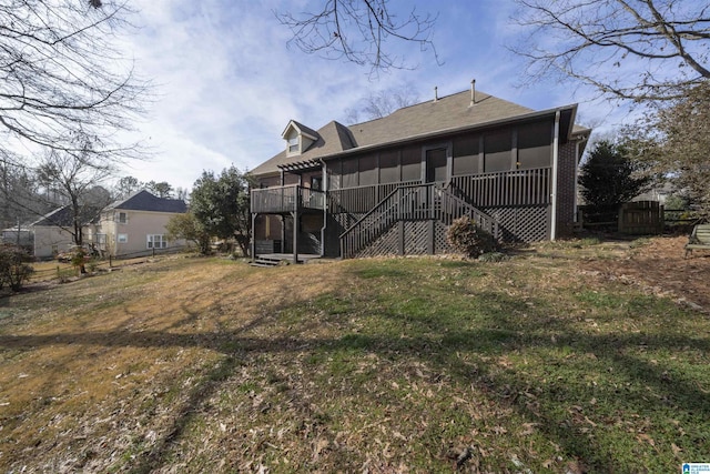 back of property featuring a yard, a sunroom, and a deck