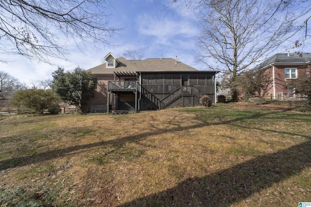 back of house with a yard and a sunroom