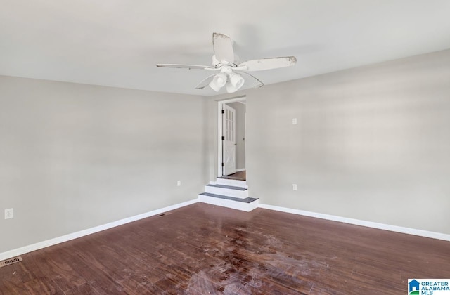 spare room with ceiling fan and wood-type flooring