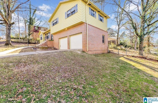 view of property exterior with a yard and a garage