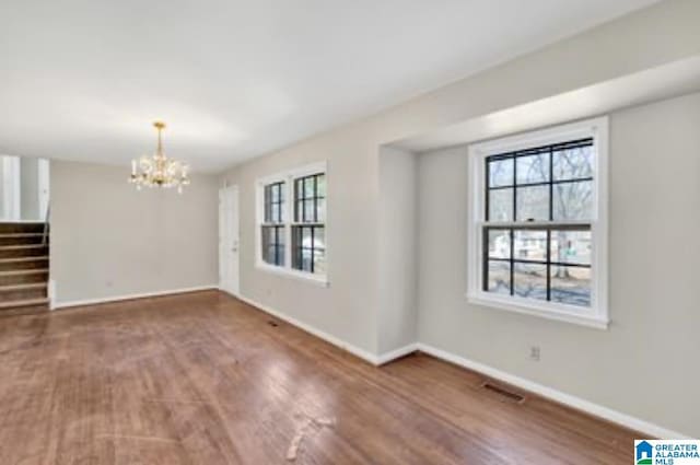 interior space featuring dark wood-type flooring and a notable chandelier