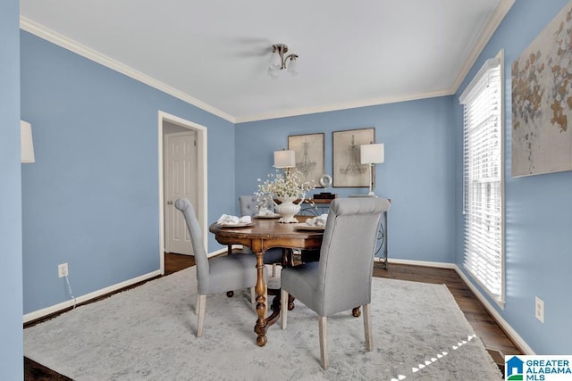 dining area with crown molding and dark wood-type flooring