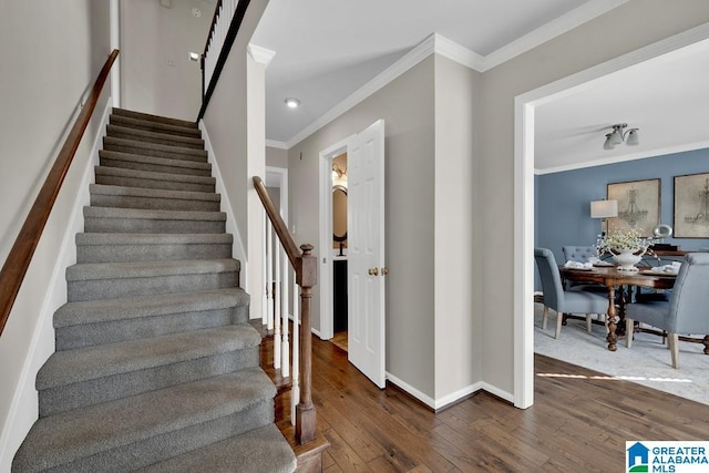 staircase featuring crown molding and hardwood / wood-style floors