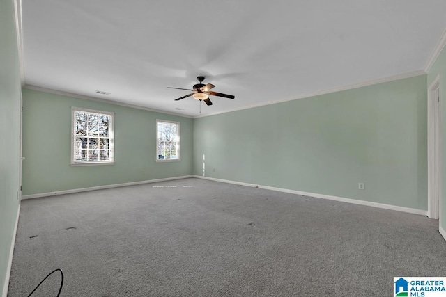 carpeted spare room featuring crown molding and ceiling fan