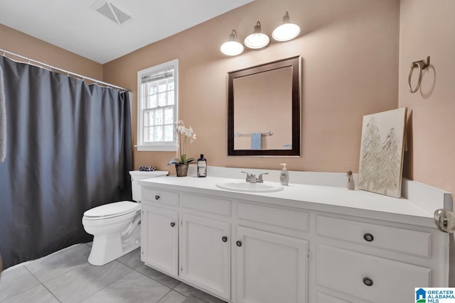 bathroom with tile patterned flooring, vanity, and toilet