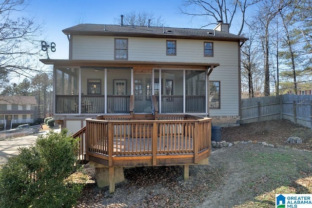 back of property featuring a wooden deck and a sunroom