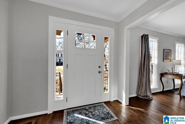 foyer with crown molding and dark wood-type flooring