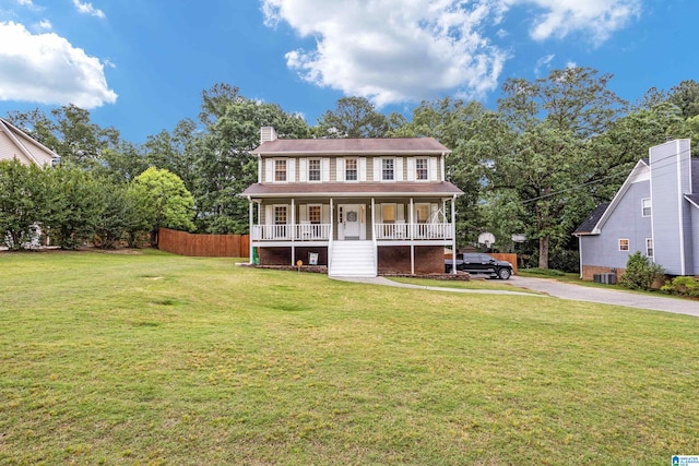 view of front of home featuring a porch, central AC unit, and a front lawn