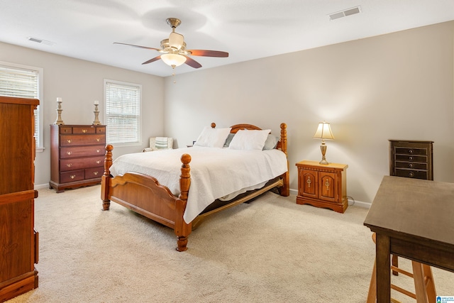 bedroom featuring light colored carpet and ceiling fan