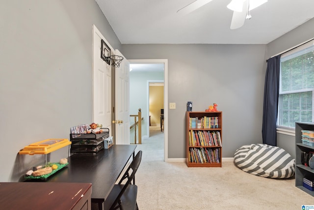 carpeted office space with ceiling fan