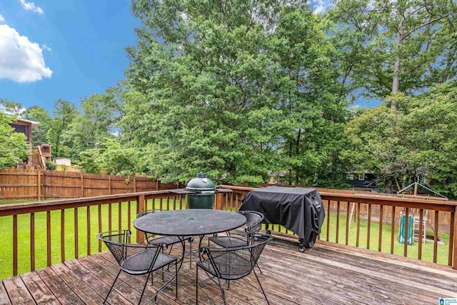 deck featuring a grill and a yard