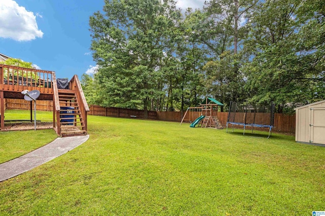 view of yard featuring a trampoline, a storage shed, and a playground