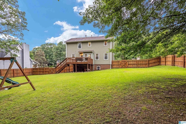 back of property with a wooden deck and a lawn