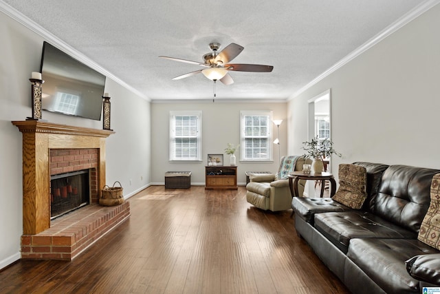 living room featuring ornamental molding, hardwood / wood-style floors, and a brick fireplace