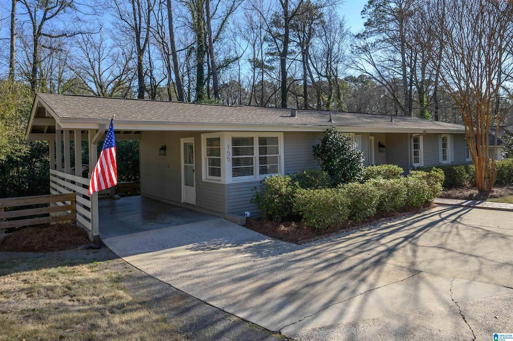 ranch-style home featuring a carport