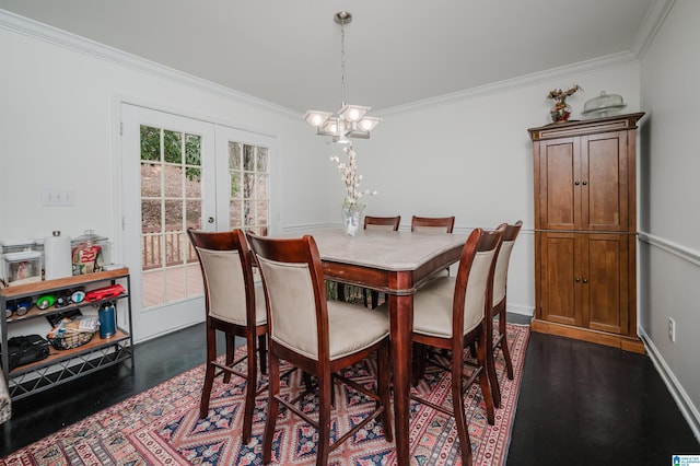 dining space with ornamental molding, an inviting chandelier, and french doors