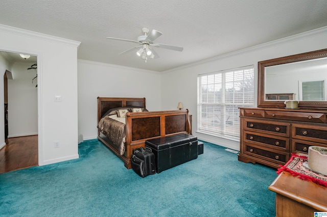 carpeted bedroom featuring crown molding, ceiling fan, and a textured ceiling