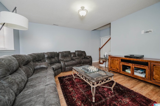 living room featuring hardwood / wood-style flooring and a textured ceiling